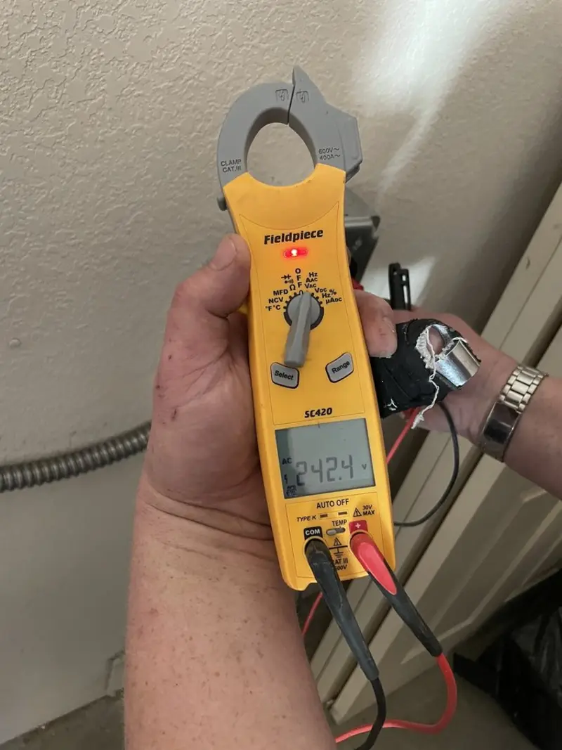 Voltage testing with clamp meter during Outlet Installation in Fairfield Plantation